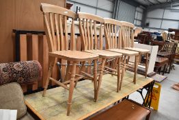 A set of four traditional kitchen chairs having beech backs with ash seats on turned frames