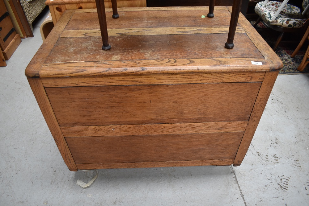 An early to mid 20th Cetury oak panelled bedding box, on Shepherds style casters