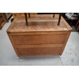 An early to mid 20th Cetury oak panelled bedding box, on Shepherds style casters