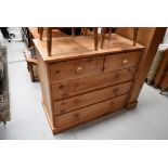 A natural pine chest of two over three drawers
