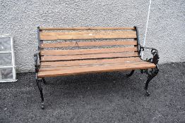 A vintage garden bench having been restored having lion head decoration