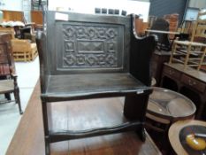 A antique oak monks bench having carved back