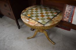 A vintage Onyx and brass coffee table with 'chequer board' top, diameter approx. 55cm