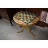 A vintage Onyx and brass coffee table with 'chequer board' top, diameter approx. 55cm