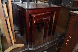 A modern rosewood effect nest of three tables