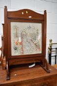 An art deco fire screen having hand sewn depiction of garden