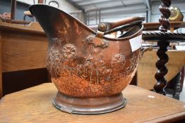 A traditional copper coal helmet having embossed decoration