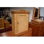 A natural pine bathroom or similar wall cabinet