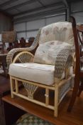 A modern canework conservatory easy chair with upholstered seat and back