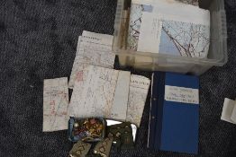 A box containing MOD Ordnance Survey Maps, Army School of Civil Defence Instructor Notes Training