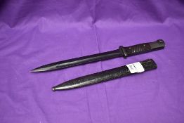 A Geman WW2 Period M84/98 Bayonet with ribbed plastic grip, metal scabbard, makers marks J.SCH, on