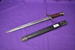 An Italian Model 1891 Carcano Bayonet for the Mannlicher-Carcano Rifle with metal and leather