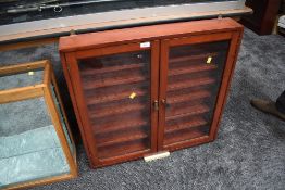 A wall mounted display cabinet having seven shelves