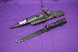 A Argentina Socket Bayonet with metal scabbard and leather frog, no marks seen, overall length 29cm