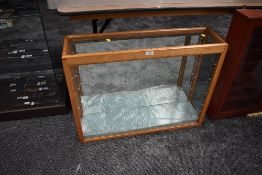 A wood and glass display case three glass shelves