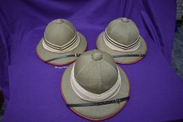 Three Kharki Pith Helmets, size 57 x2 and 58 all with cream and brown band, all with chin straps