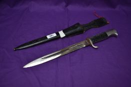 A WW2 German Dress Bayonet 1939-45 with single quillion crossguard, leather frog, metal scabbard,