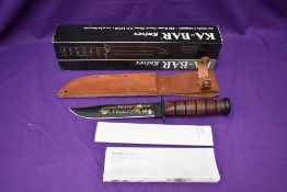 A Ka-Bar Knife, US Army operation Iraqi Freedom, with leather scabbard, overall length 31cm, in