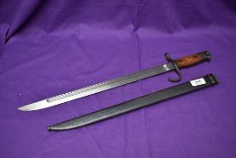 A Japanese Arisaka Model 1897 Bayonet with metal scabbard, blade has Kokura Arsenal mark and grip