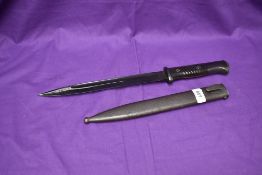 A German WW2 Period M84/98 Bayonet with ribbed plastic grip, metal scabbard, marks seen C9166, on