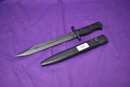 A British 1958 SLR Bayonet with metal scabbard, blade marked Arrow 59, grip marked L1A3 960-0257B,