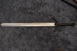 A reproduction two handled Broadsword, round pommel, wire grip and downward pointing crossguard,