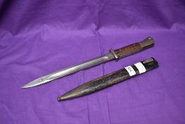 A German WW1 1884/98 Bayonet, wood and metal grip, makers marks Crown with ER Furt, blade edge