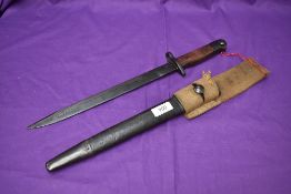 A 1942 India Pattern Bayonet with metal and leather scabbard and webbing frog, blade marked NWRII,