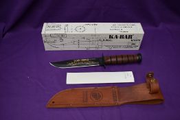 A Ka-Bar Knife, Celebrating 100 years of Ka-Bar, with leather scabbard, overall length 31cm, in