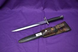 A Swisss Sig 57 Bayonet with metal scabbard and leather frog, blade marked WF (WaffenFabrik), on