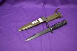 An American 1964 Second Model M16 Rifle Bayonet, metal scabbard and webbing frog, no marks on blade,