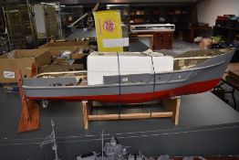 A part built remote control model ship, with control unit