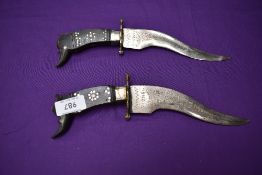 A pair Indian Daggers with recurving single edged blades, decorated blades and wood grips