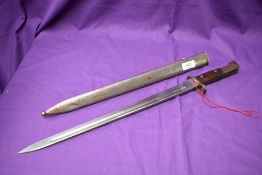 A Belgium 1898 FN Export Bayonet with long blade and metal scabbard, no marks seen, blade length