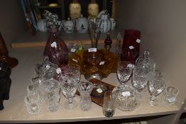 A selection of colour and clear cut crystal glass wares including Cranberry and Royal Doulton wine