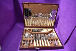 A wooden canteen containing silver plated and stainless steel cutlery