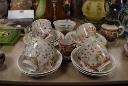 A selection of tea cups and saucers by Hilditch in a Chinoiserie design having London style handles