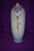 A tall Franz vase having cream and green tones to ground and lilac iris pattern. With cut out