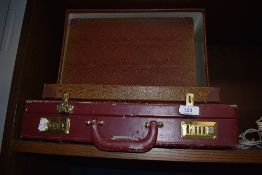 A Brief case and two vintage style storage boxes.