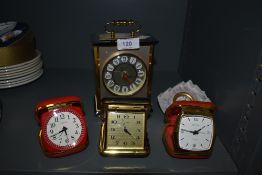 Three vintage travel clocks and a carriage/mantel clock also included is a Lladro ceramic clock.