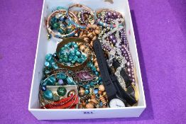 A selection of costume jewellery including strings of beads, bangles and wrist watches