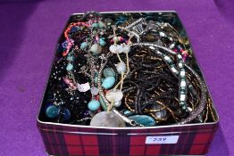 A tin of costume jewellery fashion necklaces