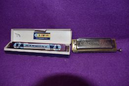 A boxed vintage Harmony harmonica and Koch-Harmonica in C.