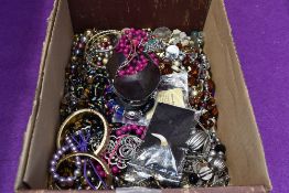 A selection of costume jewellery including strings of beads and bangles