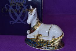 A Royal Crown Derby Unicorn paper weight having gold stopper,with box,1394 of 2000.