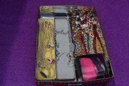 A small selection of costume jewellery including strings of beads, diamante wrist watch etc