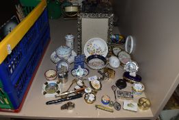 A selection of curios and trinkets including spoons pill boxes and Ibelo m23 cigarette lighter