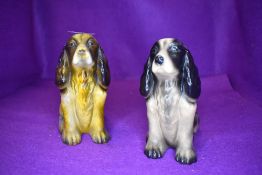 Two cocker spaniel figurines.