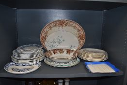 An assortment of vintage ceramics including Meakin plates, platters and bowls.