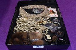 A tray of costume jewellery including strings of pearls, pearl collar, fur brooches etc